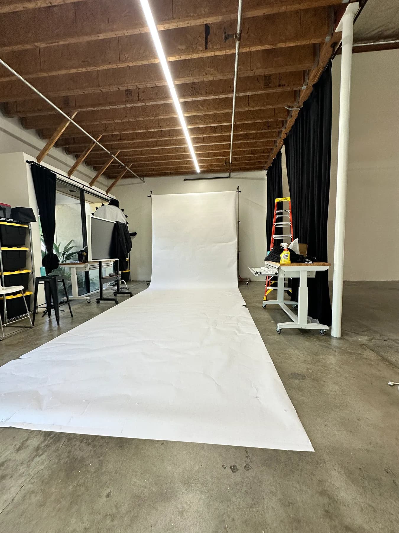 Full-length white seamless backdrop and open floor at Studio 591