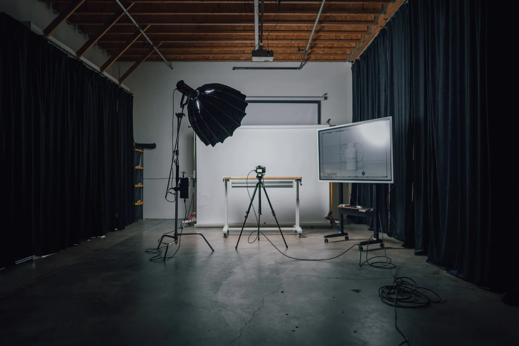 Photo production setup with seamless backdrop, camera, softbox and monitor at Studio 591
